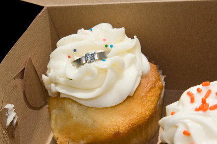 Place the engagement ring in a box of cupcakes or if you want to be less 